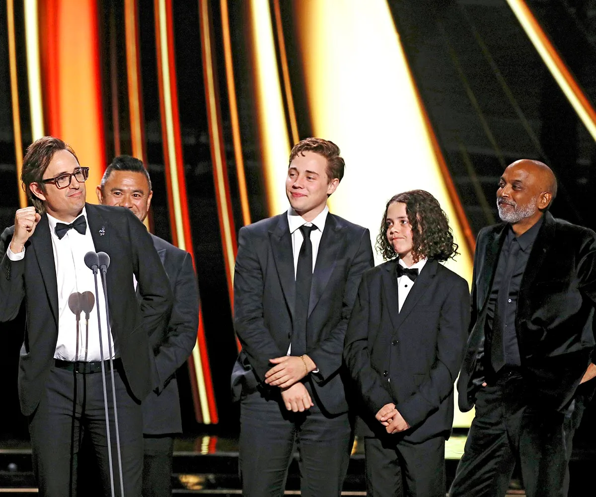 Trent Dalton, Lee Tiger Halley and Felix Cameron on stage accepting a Logie on behalf of Boy Swallows Universe