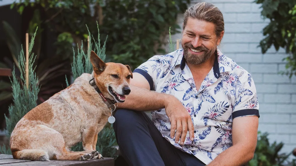 Farner Dave Grahan on bench with dog