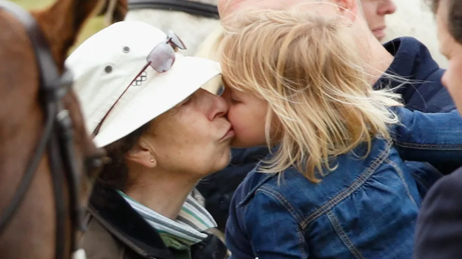 princess anne gives young blonde granddaughter kiss on the cheek