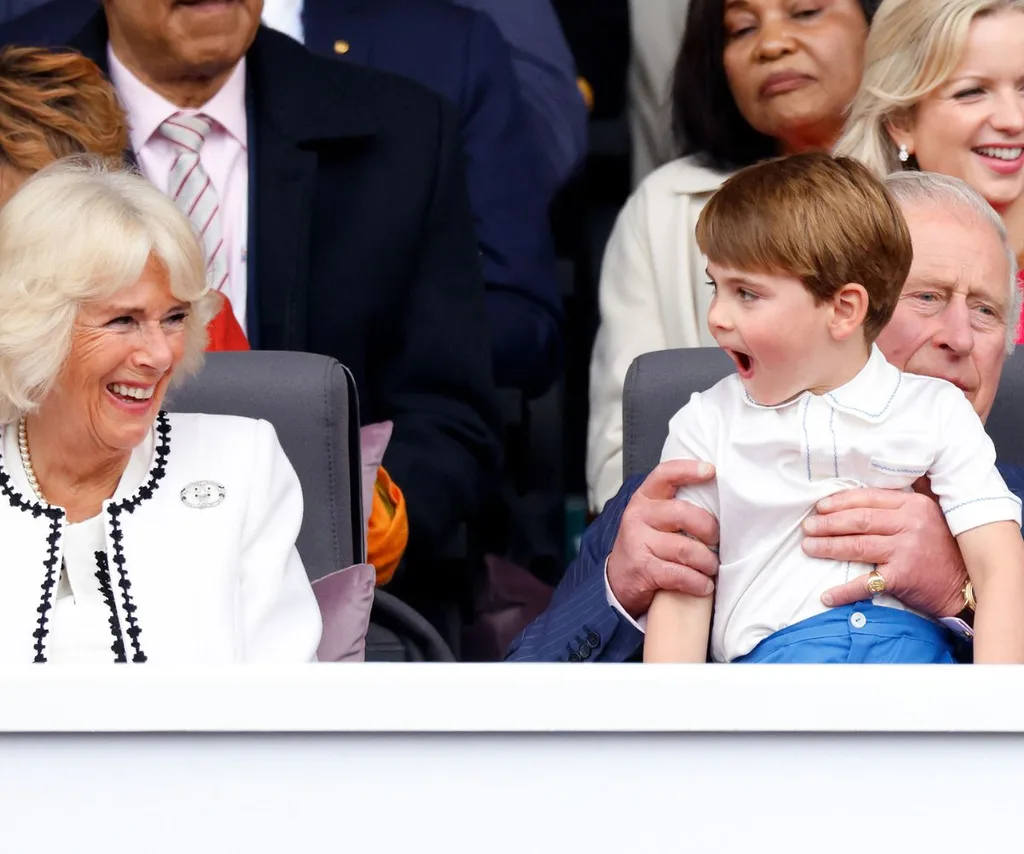 queen camilla laughs at a cheeky prince louis on King Charles' lap