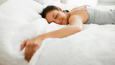 woman happy lying on her bed