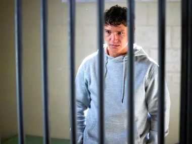 Perri (Cantona Stewart) stands behind bars as he faces prison for killing his father.