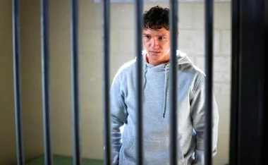 Perri (Cantona Stewart) stands behind bars as he faces prison for killing his father.