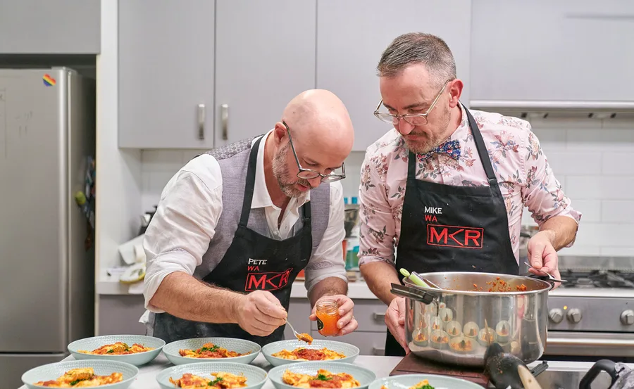 Pete and Mike are plating up food in their kitchen during their instant restaurant.