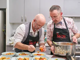 Pete and Mike are plating up food in their kitchen during their instant restaurant.