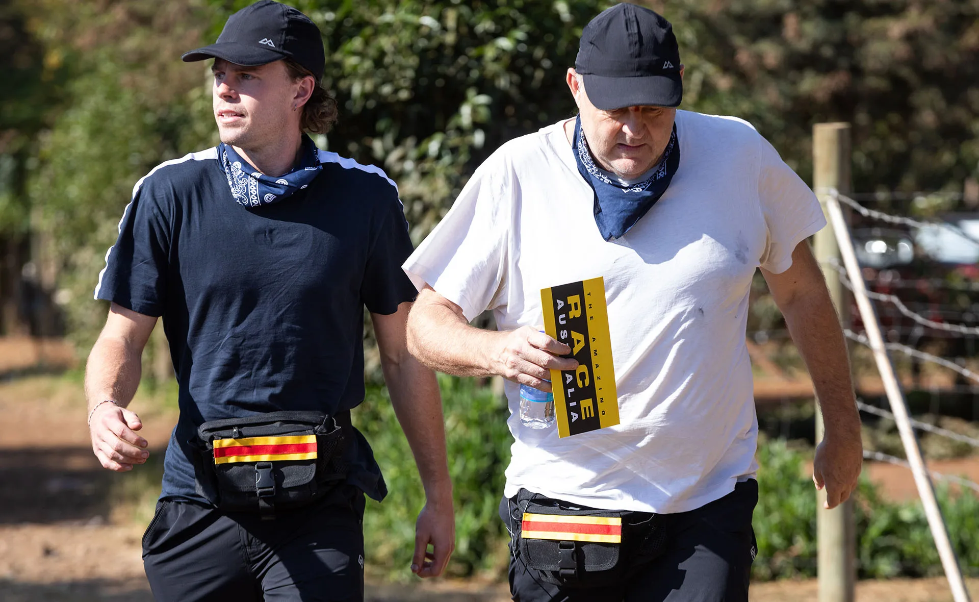 Oscar and Billy Brownless walk along a dirt track while competing on The Amazing Race Australia: Celebrity Edition.