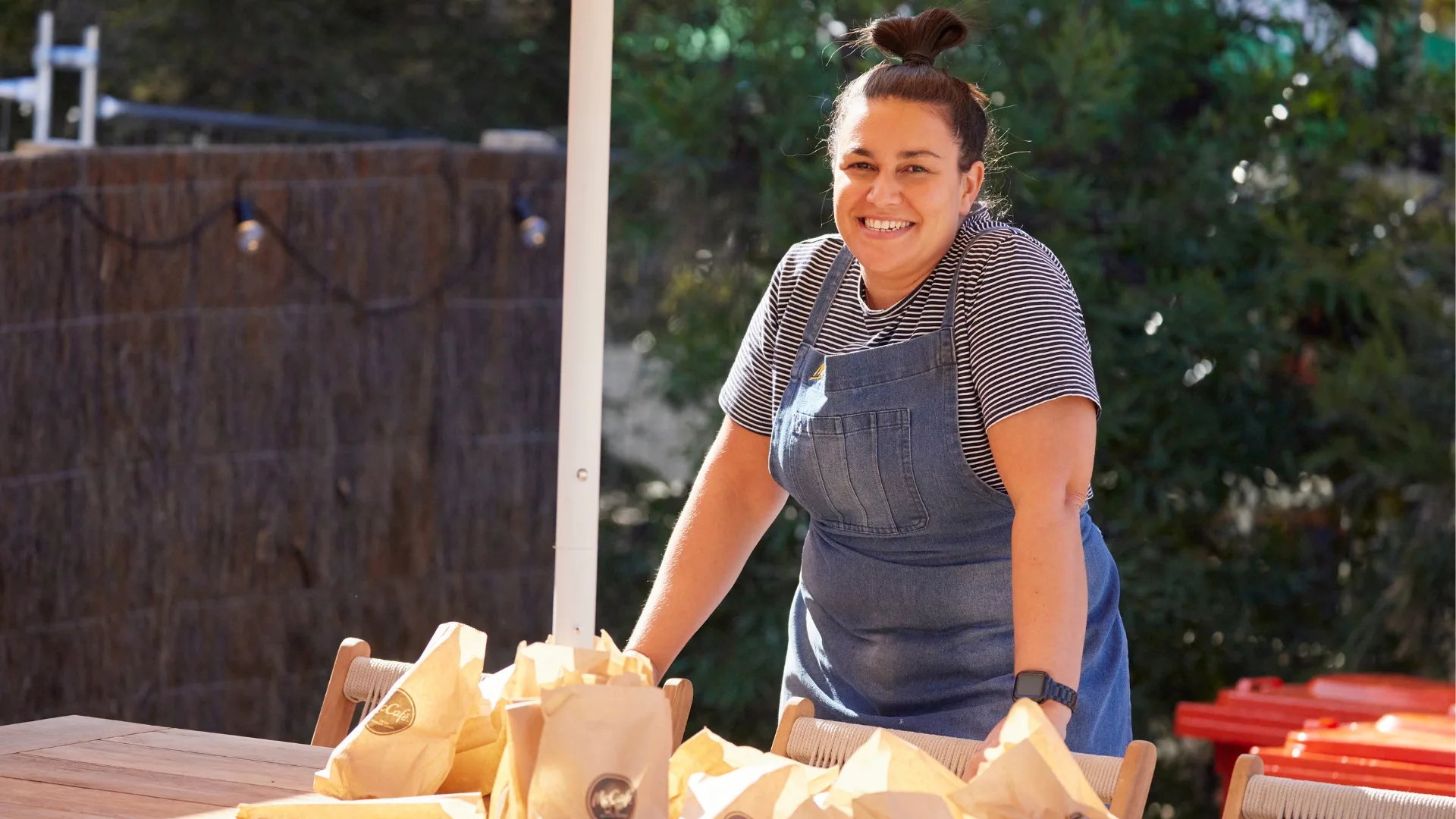 An image of a smiling Tina, the barista from The Block.
