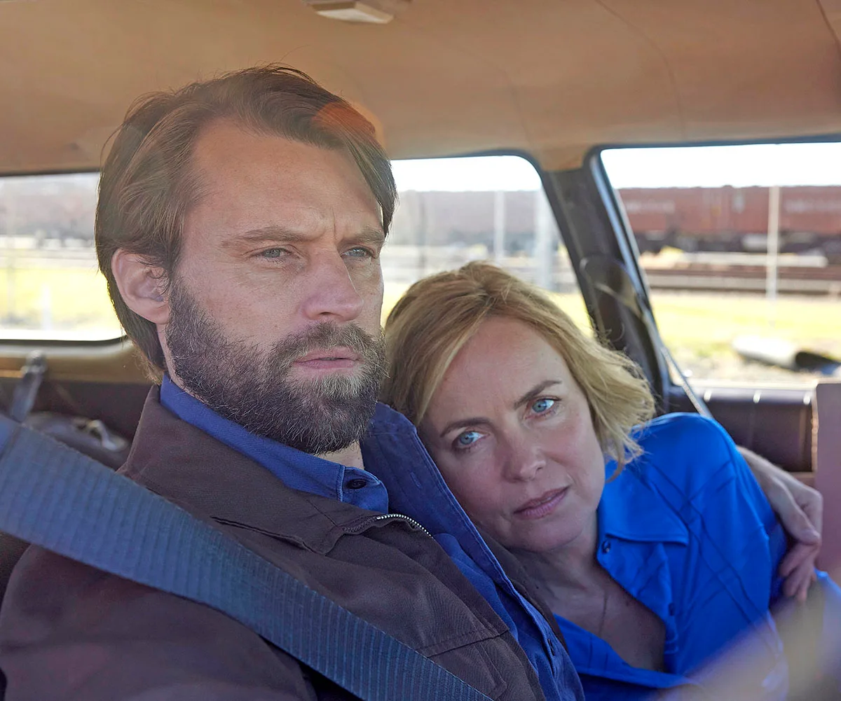 Radha Mitchell rests her head on Jesse Spencer's shoulder while sitting in the front of a car in a scene from Last Days Of The Space Age.