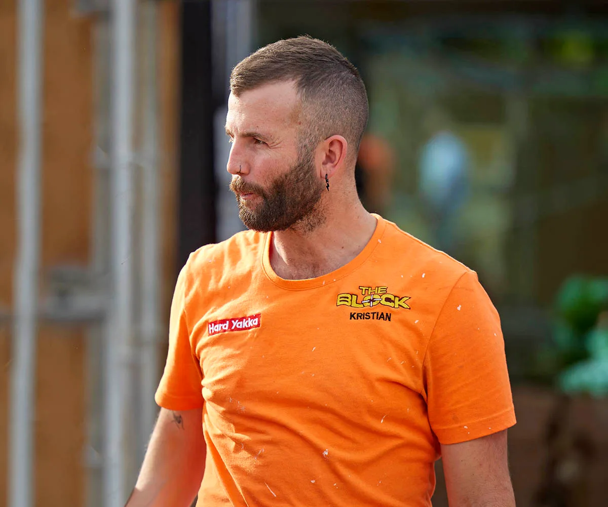 Kristian in his orange The Block shirt looking stressed on site