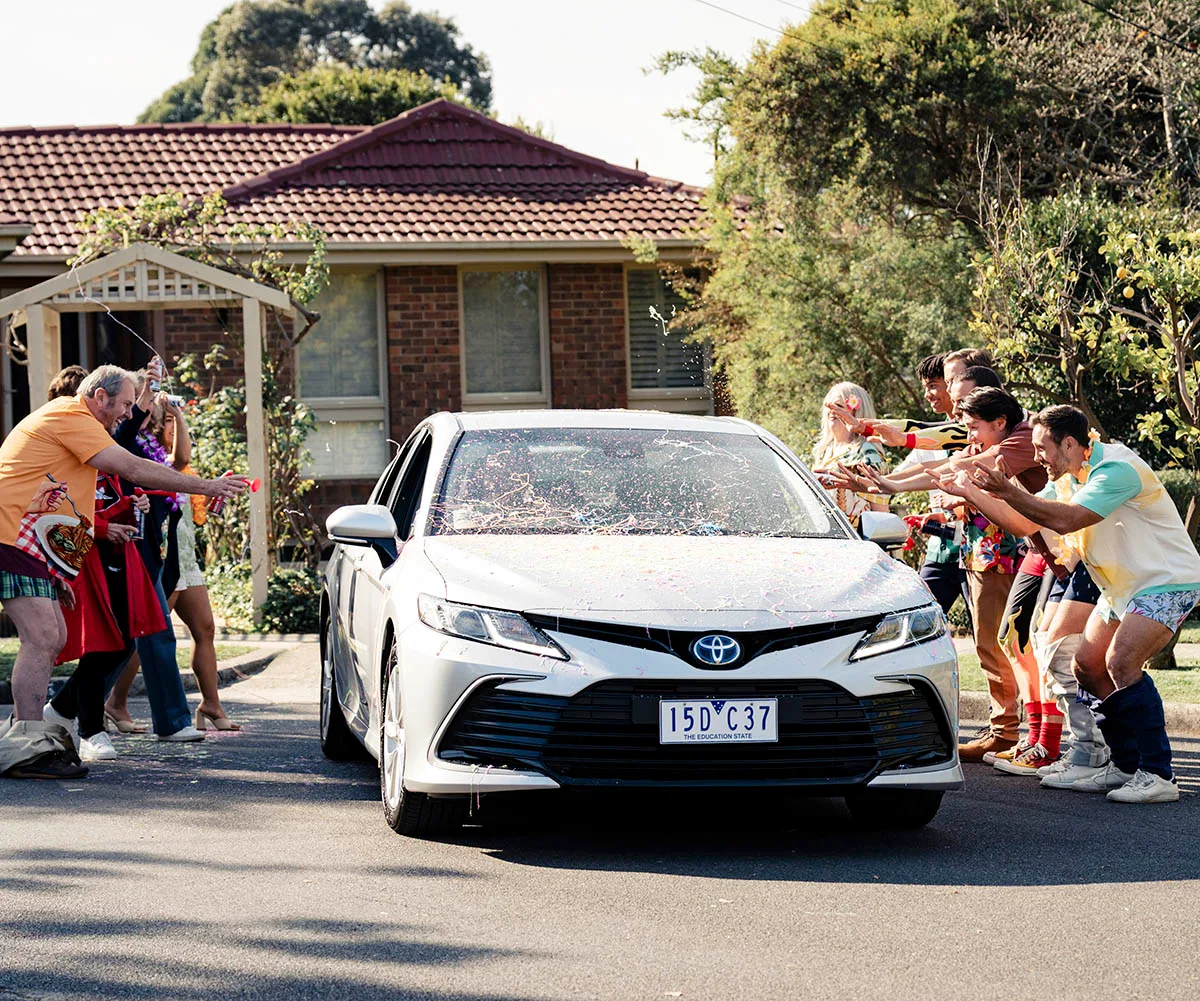 Everyone surrounds Toadie's car to send him off as he leaves Ramsay Street