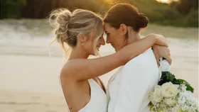 emily gielnik and temica's embrace at their wedding