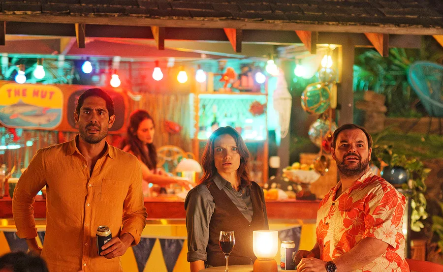 Tai Hara, Anna Samson, and Lloyd Griffith looked shocked as they stand together in a bar.