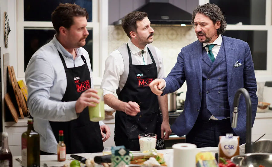 My Kitchen Rules judge Colin Fassnidge makes a point to Rob and Liam in their kitchen.