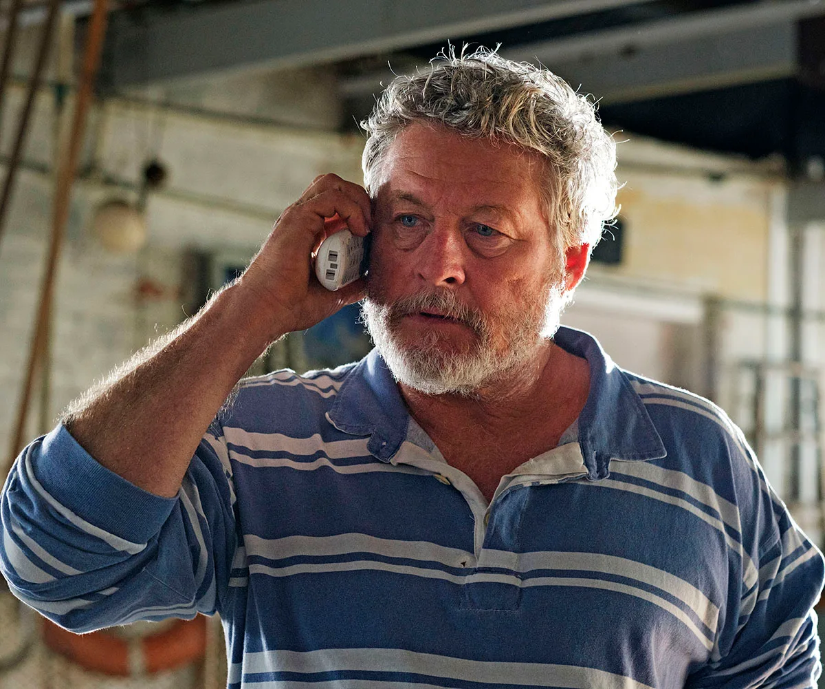 Australian actor Peter Phelps takes a concerning phone call in the season finale of Return to Paradise