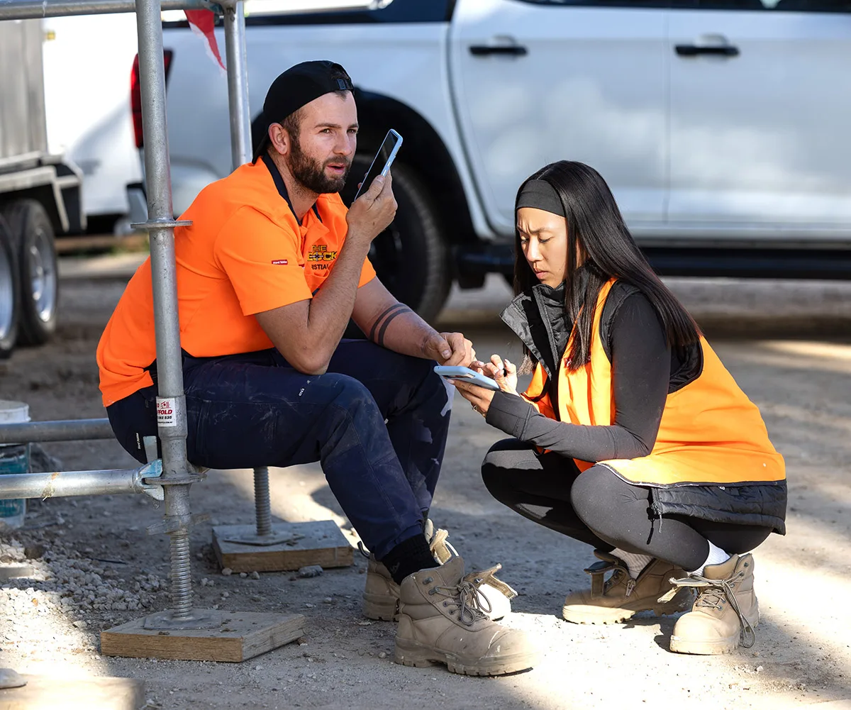 Kristian and Mimi in orange hi vis on site