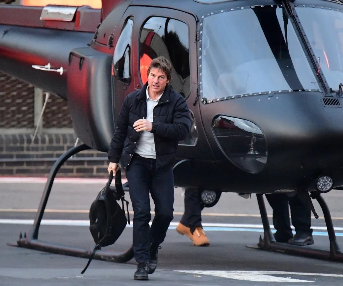 tom cruise in front of a helicopter