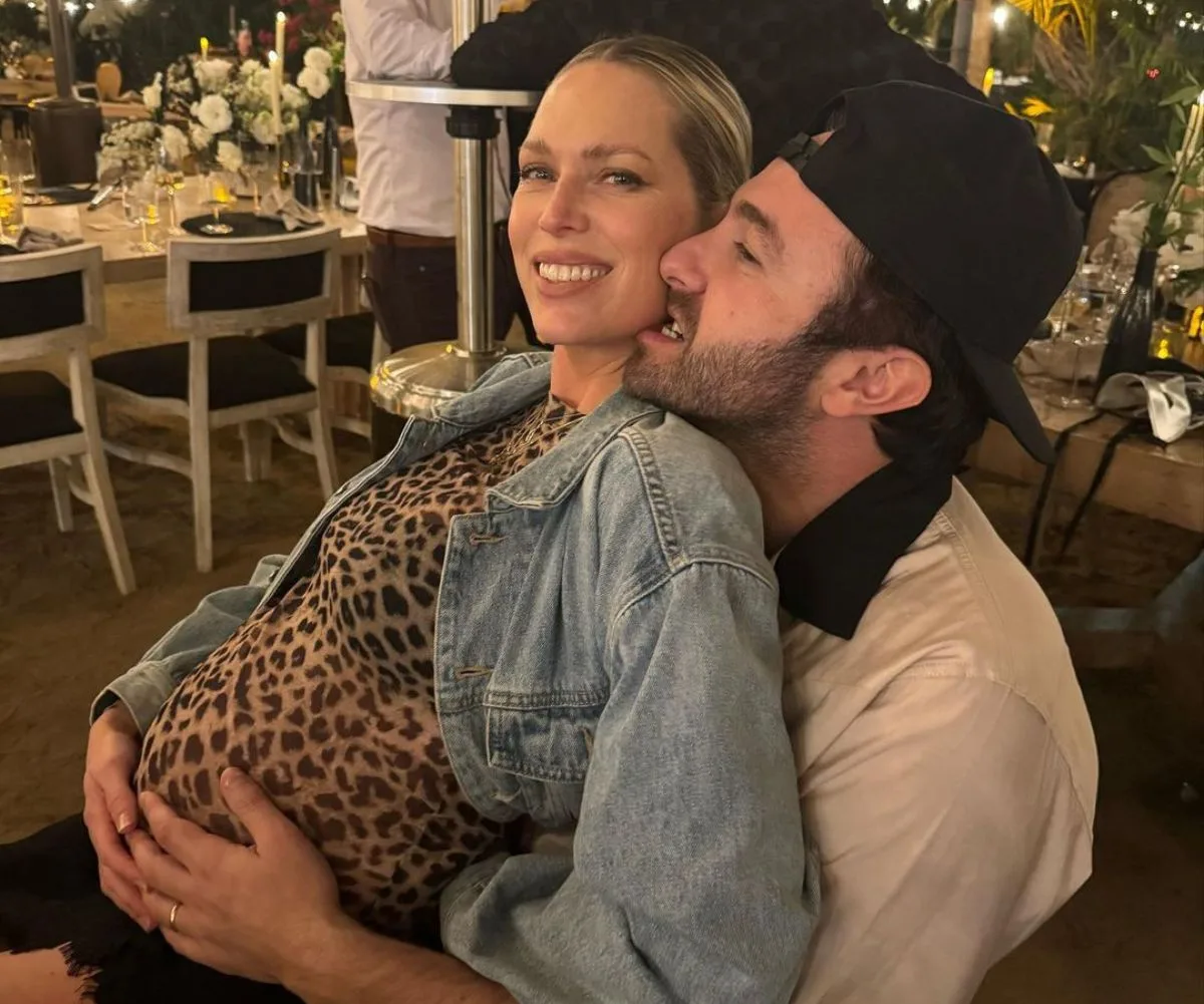 A pregnant Erin Foster with husband Simon Tikhman.