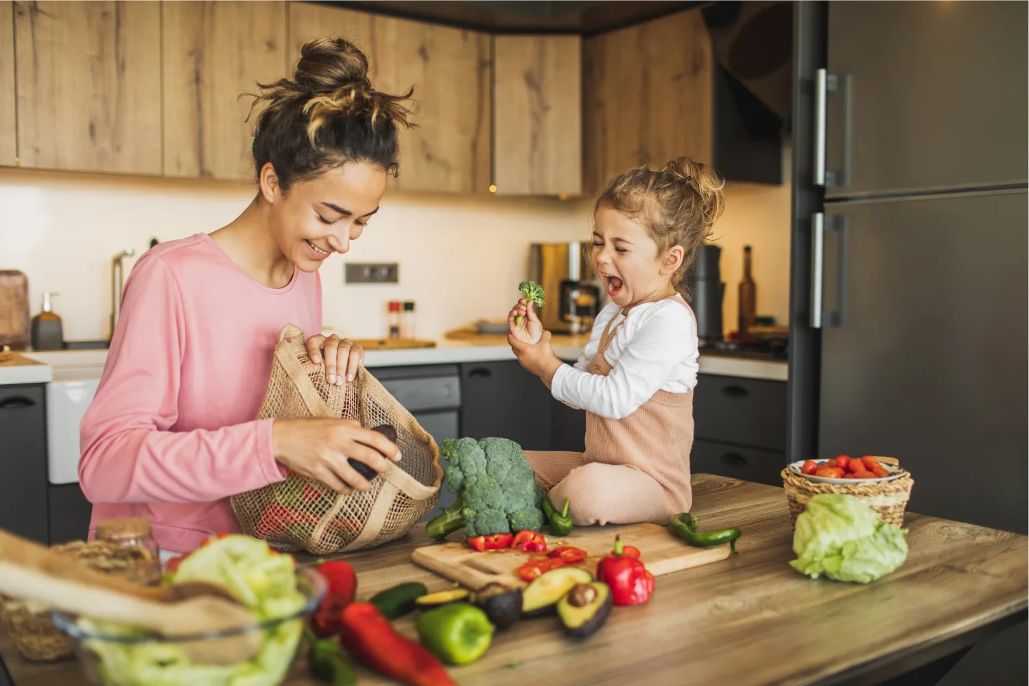 Woman and toddler preparing salad