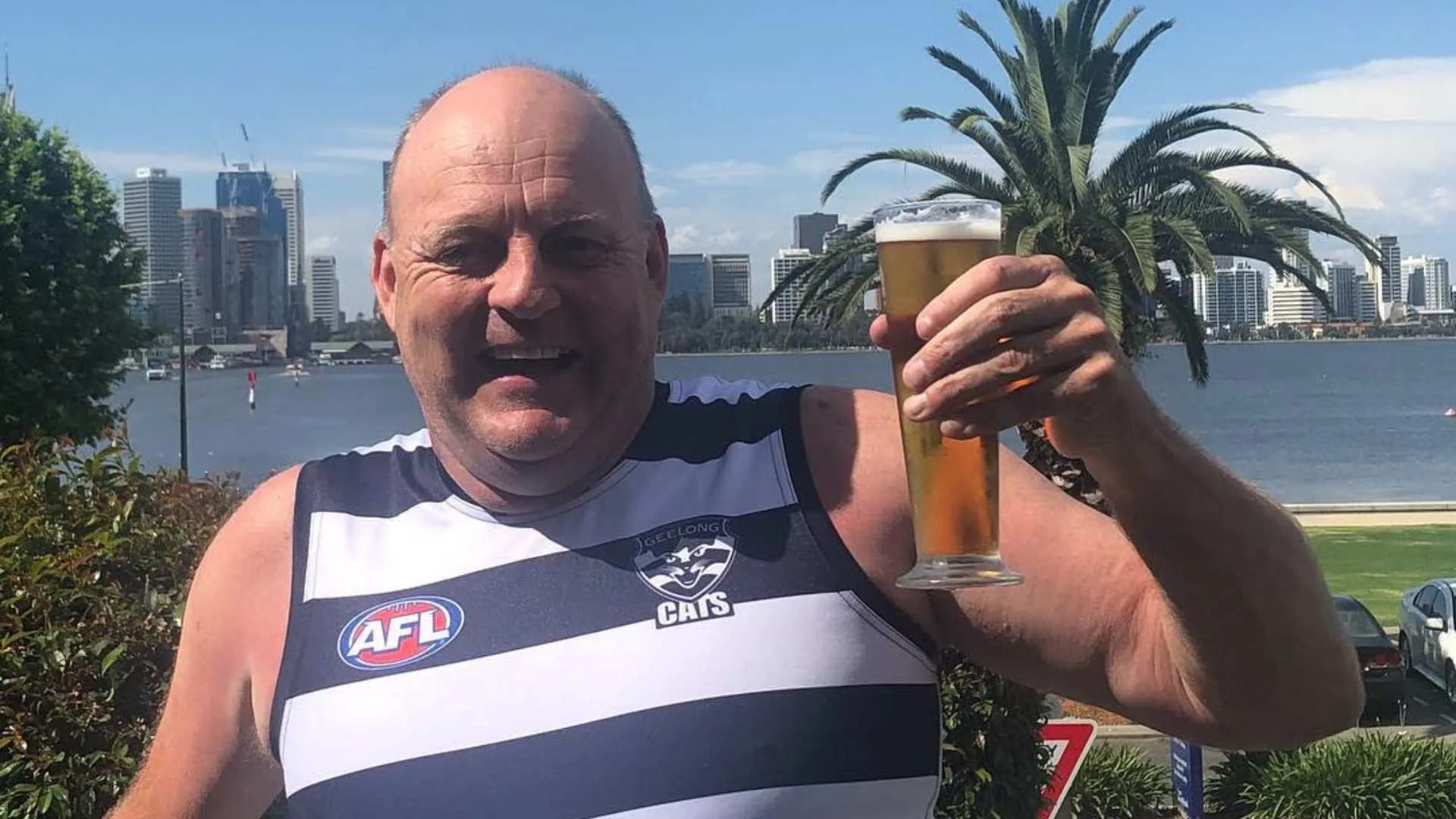 Billy Brownless holding a beer