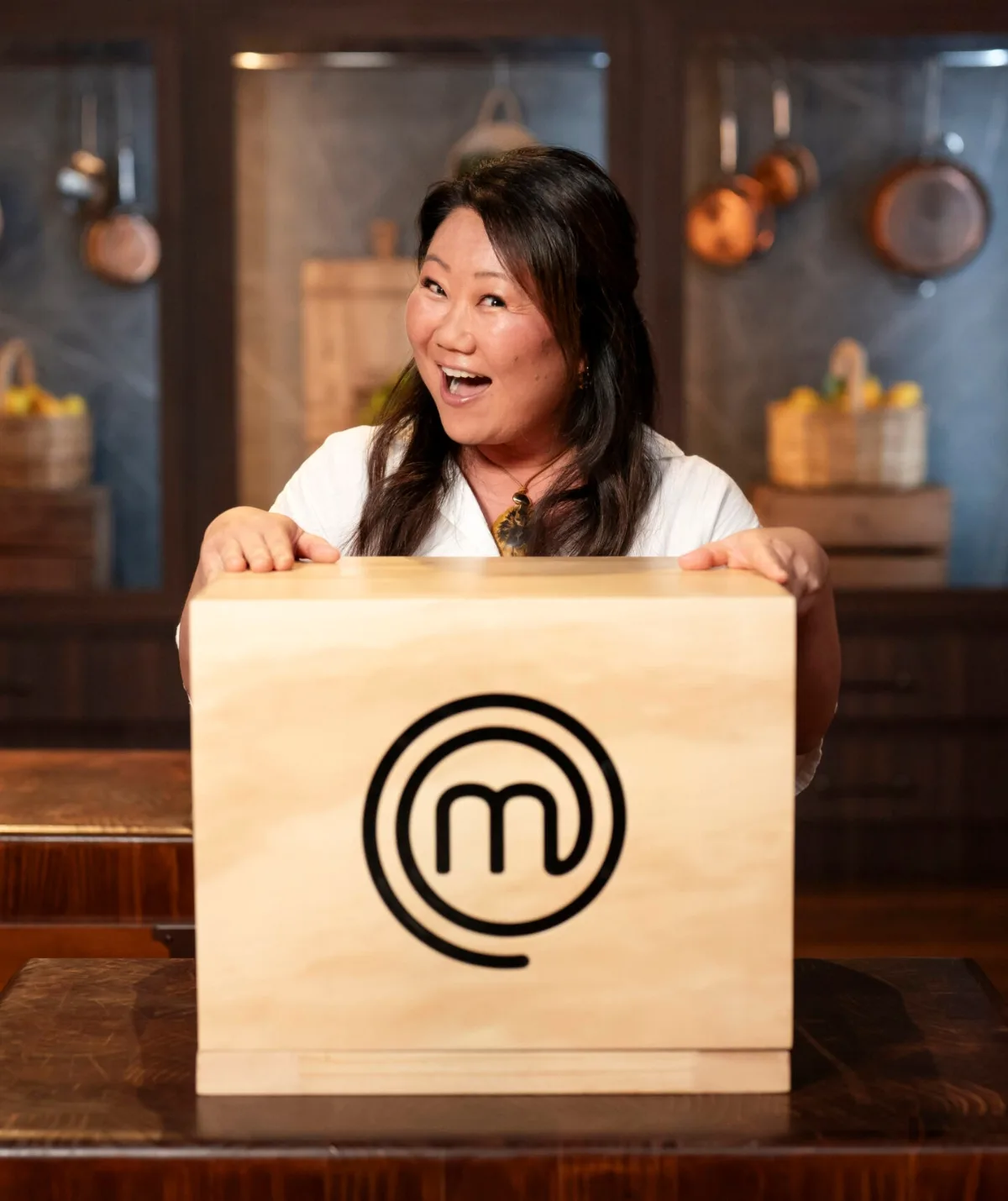 Nagi Maehashi standing behind a MasterChef mystery box.