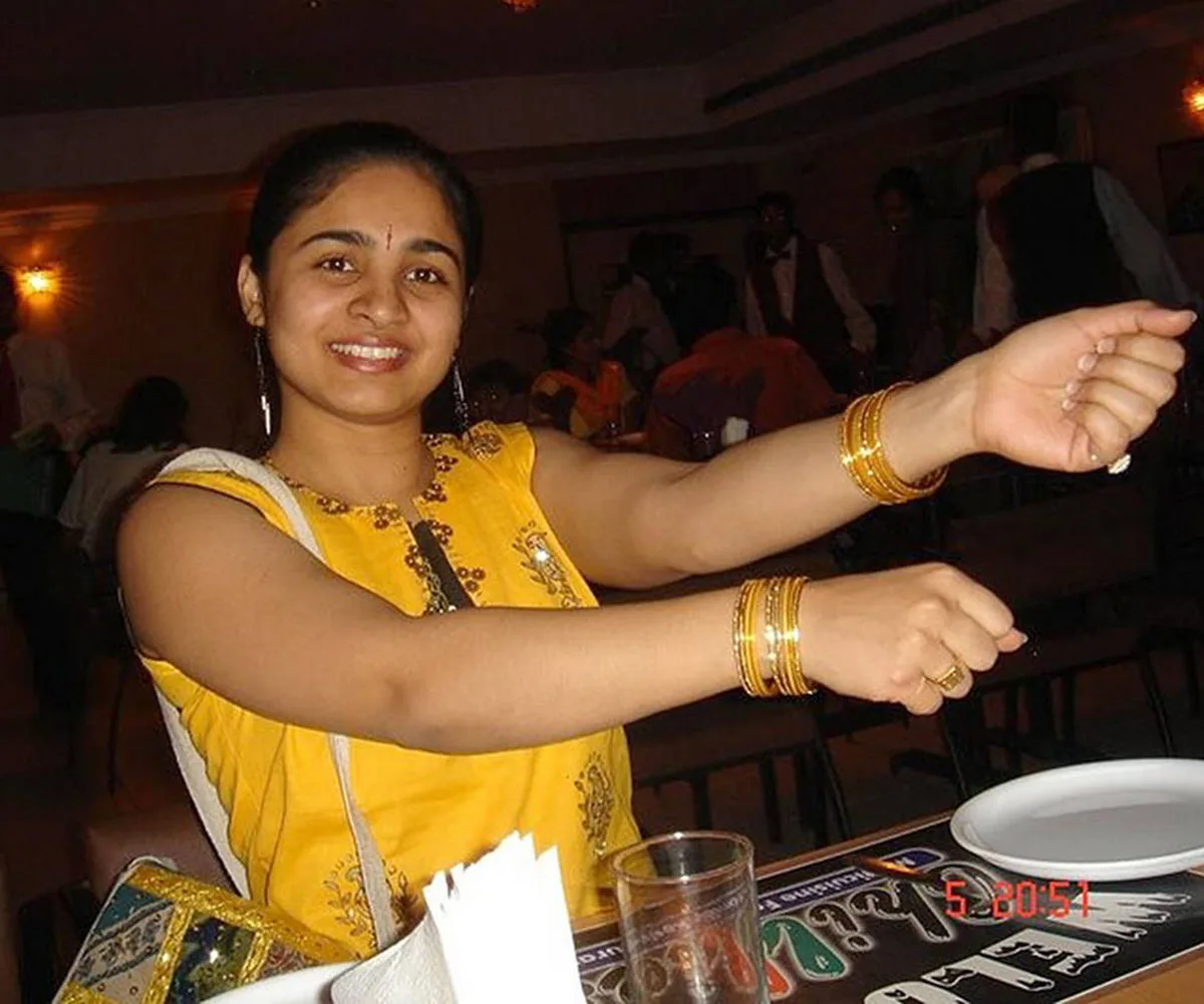 Arpana Jinaga wearing yellow top and smiling at the camera