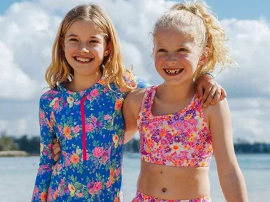 Children in bright swimming costumes