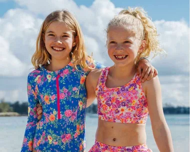 Children in bright swimming costumes