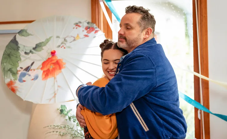 Toadie hugs a smiling Nell as she celebrates her 16th birthday