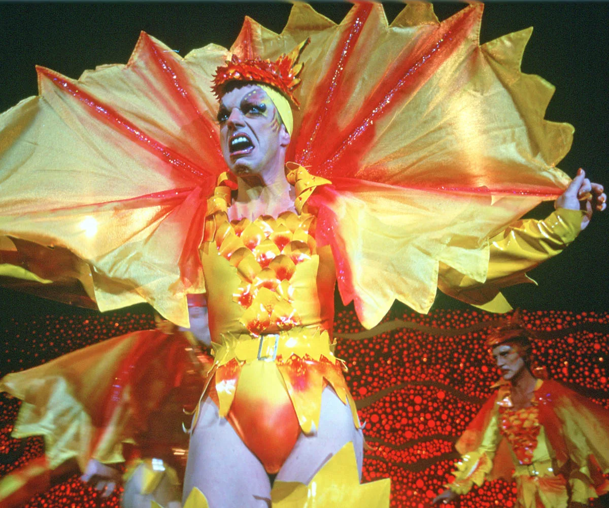 Hugo wears a lizard costume in a still from Priscilla, Queen Of The Desert