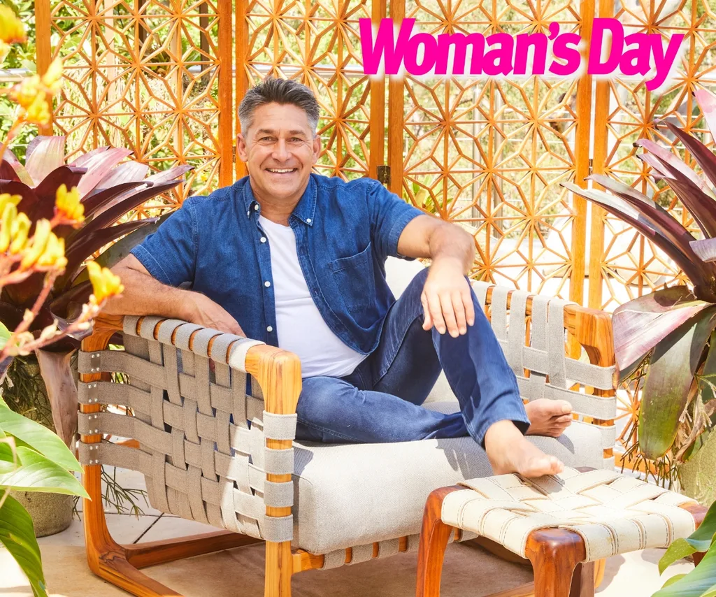 Jamie Durie sits in an outdoor chair on his patio.
