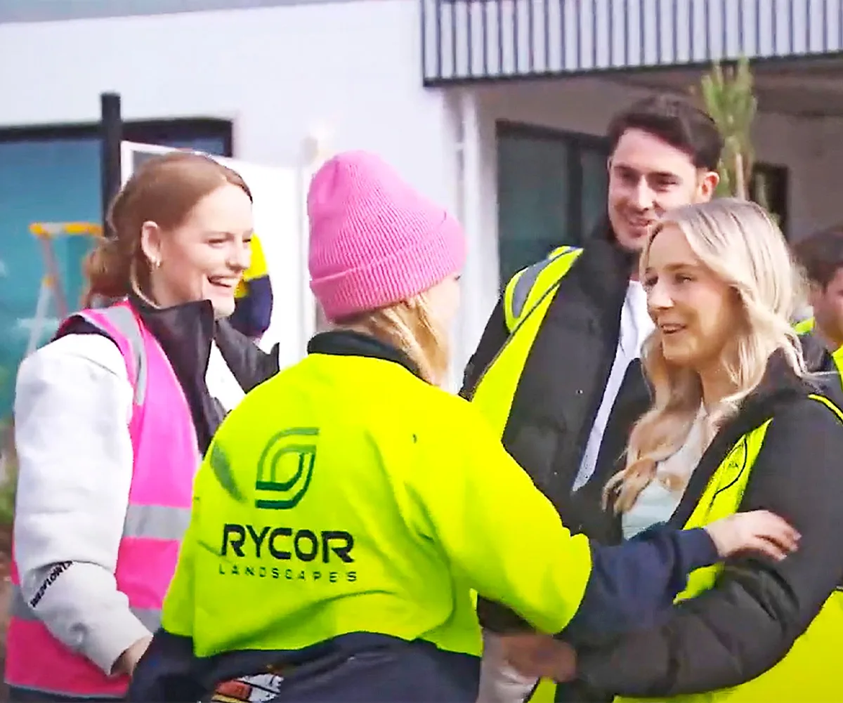 Maddy and Charlotte greet Paige and Jesse on site all in hi vis