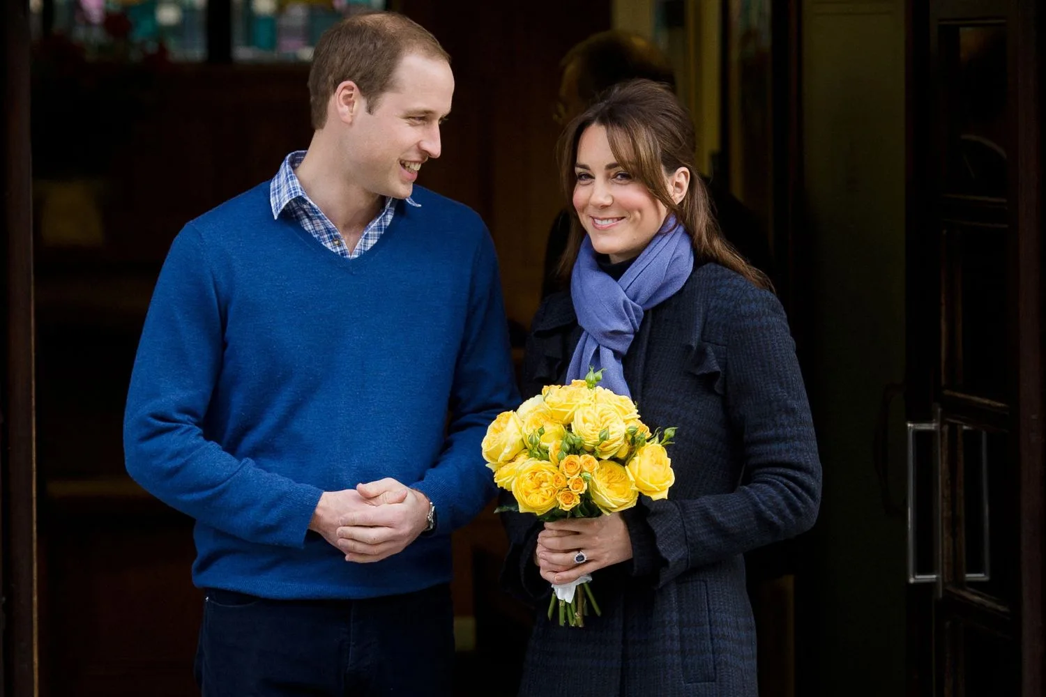 Kate holding yellow flowers with Will next to her 