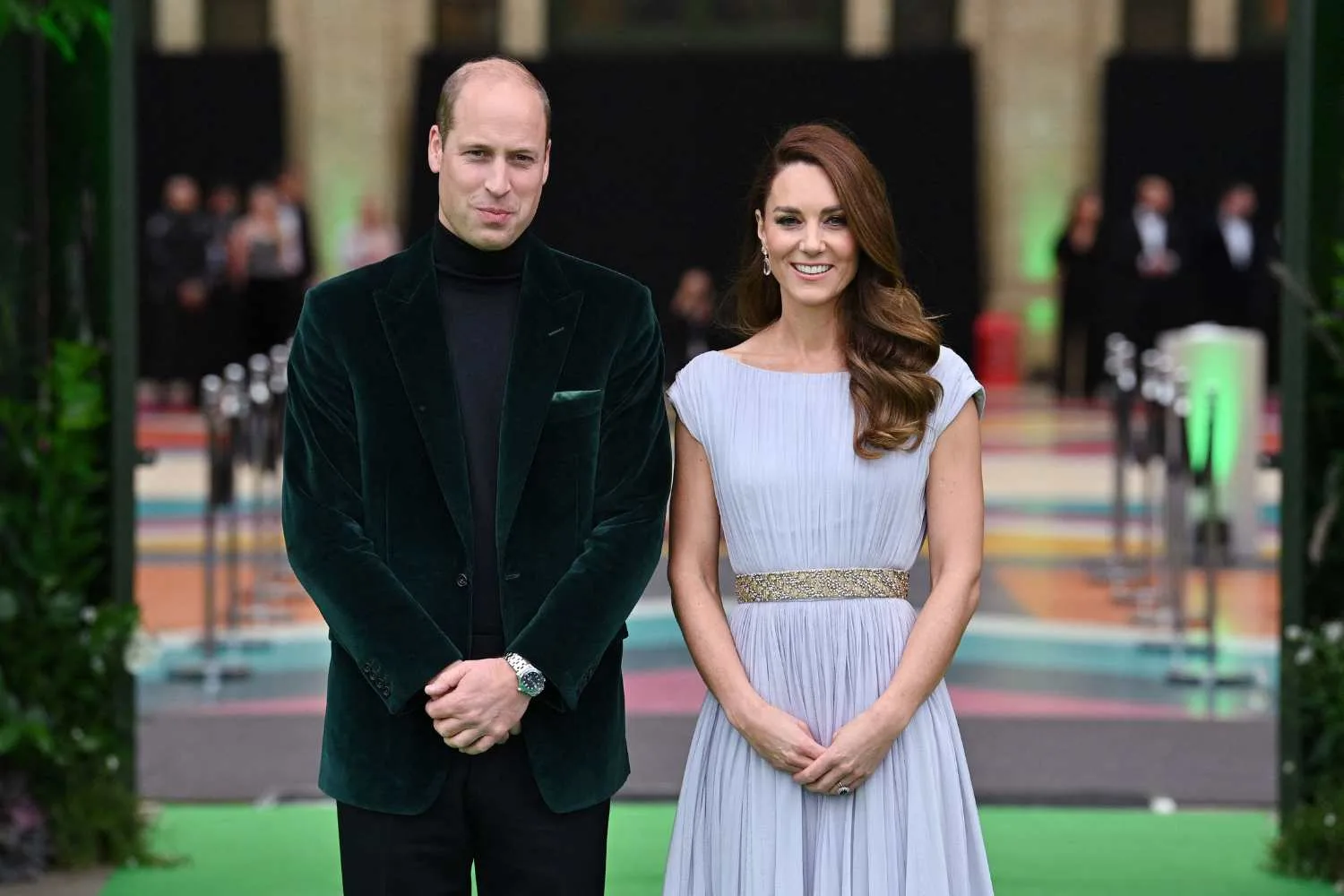 Kate Middleton in purple dress with sequinned belt with Will in black velvet suit