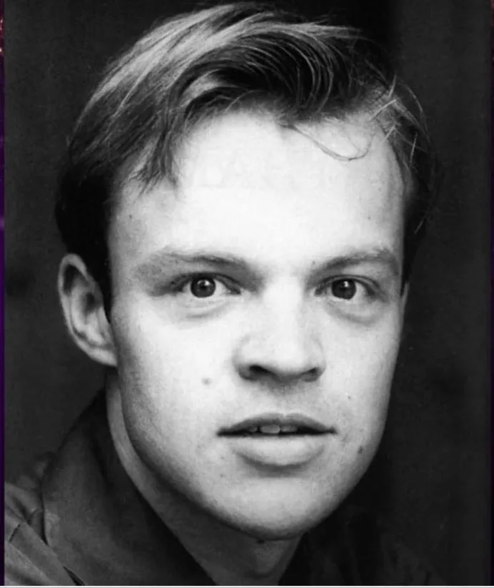 A black-and-white photo of a young Graham Norton's face. 