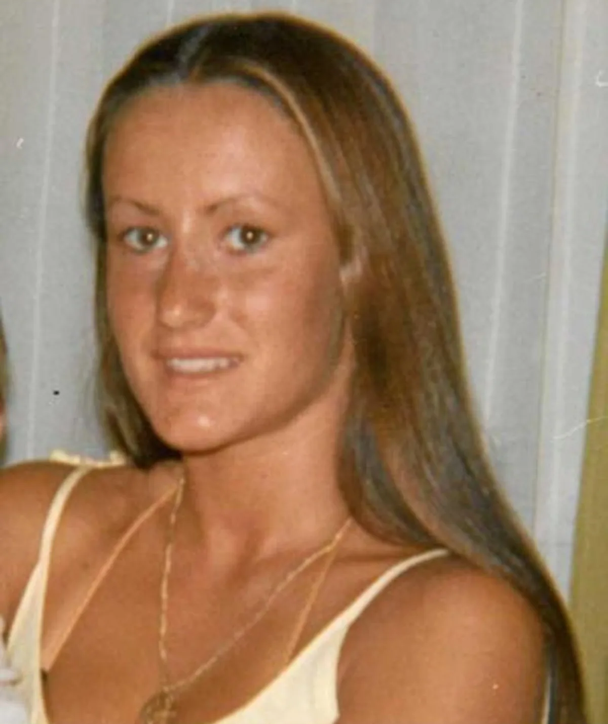 An image of Narelle Cox. She has long blonde hair and is tanned with a singlet on and a gold necklace.