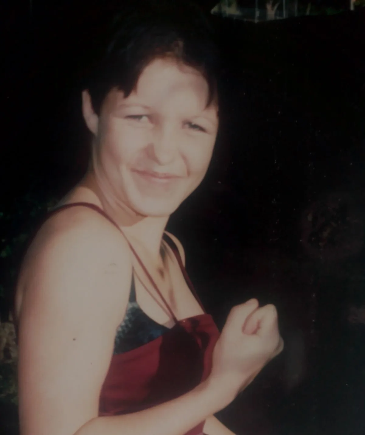 An image of Rose Howell who has short hair and is smiling. She is wearing a red singlet.