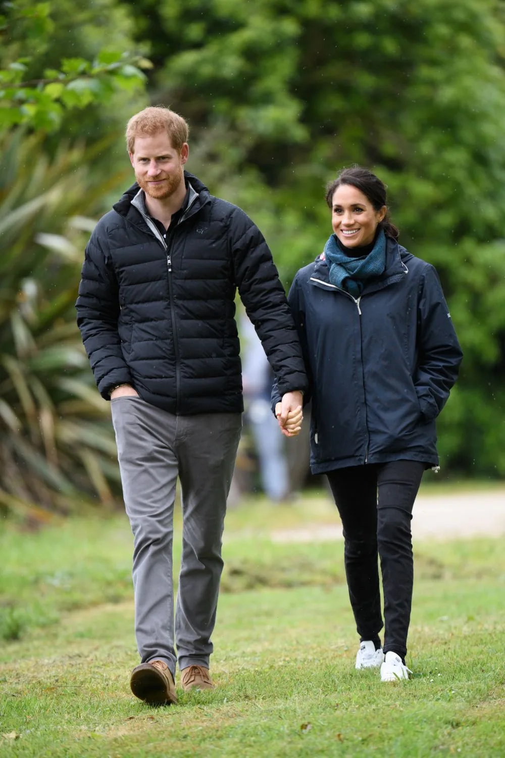 Harry in puffer jacket holding hands with Meghan Markle