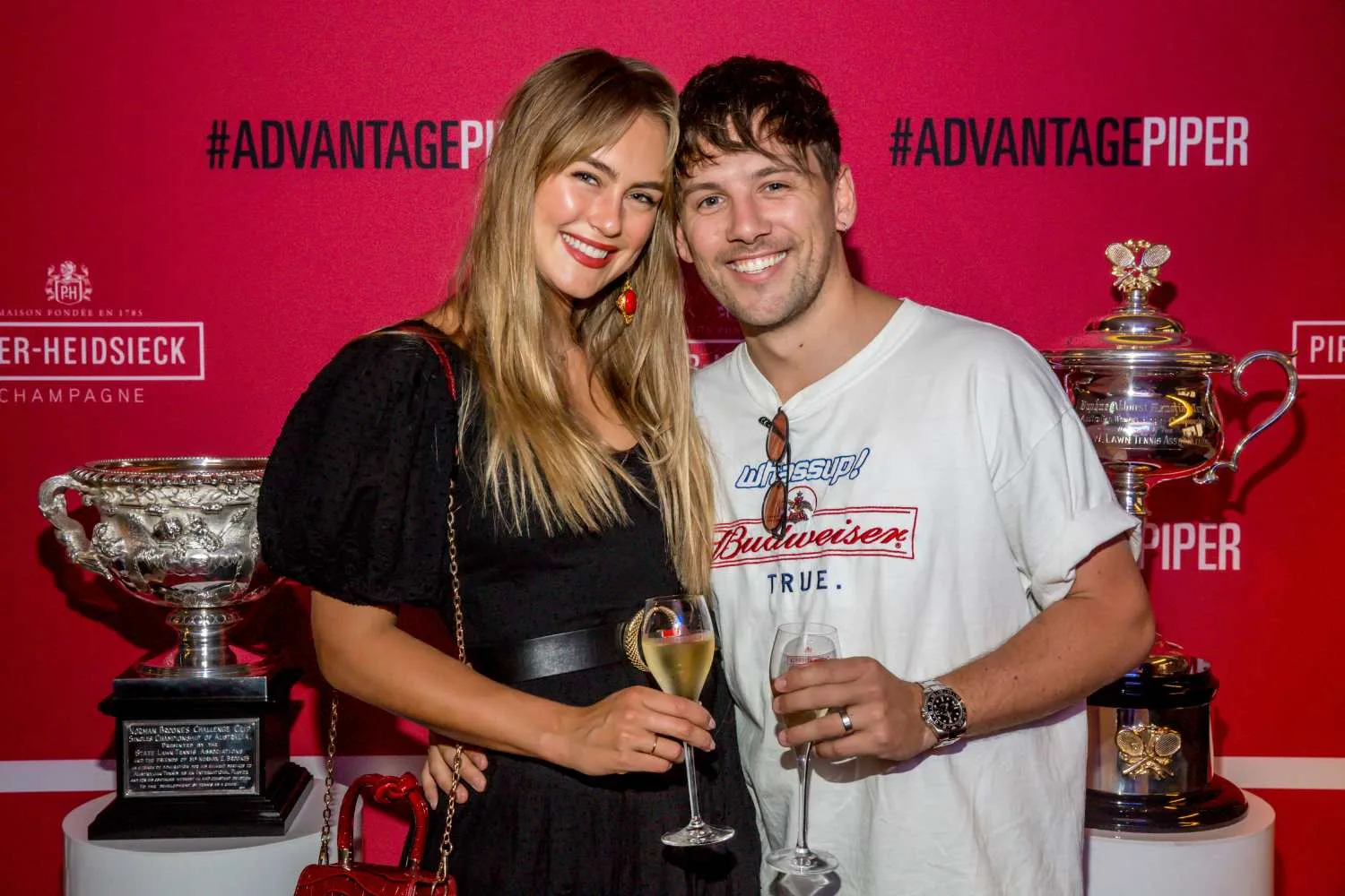 steph claire smith and husband josh celebrating with champagne