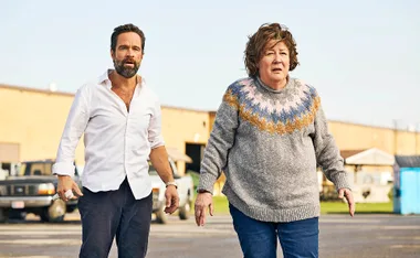 Chris Diamantopoulos as Mike and Margo Martindale as Ruth stand in the street,