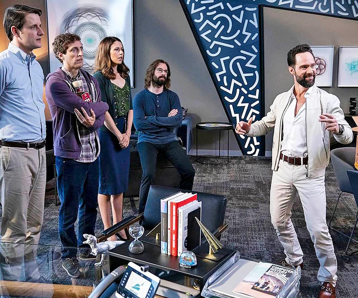 Chris Diamantopoulos standing with other cast members of Silicon Valley on the set of the show.  