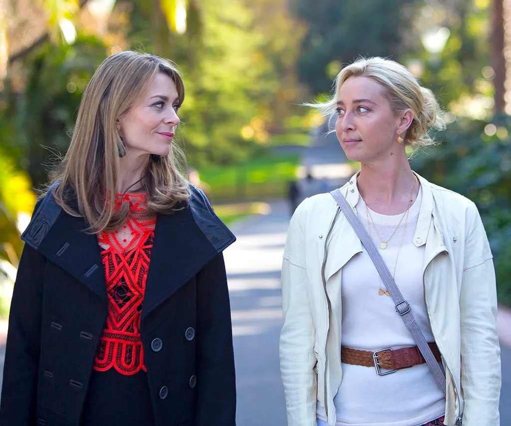 Kat stands next to actress Asher Keddie in a still from Offspring
