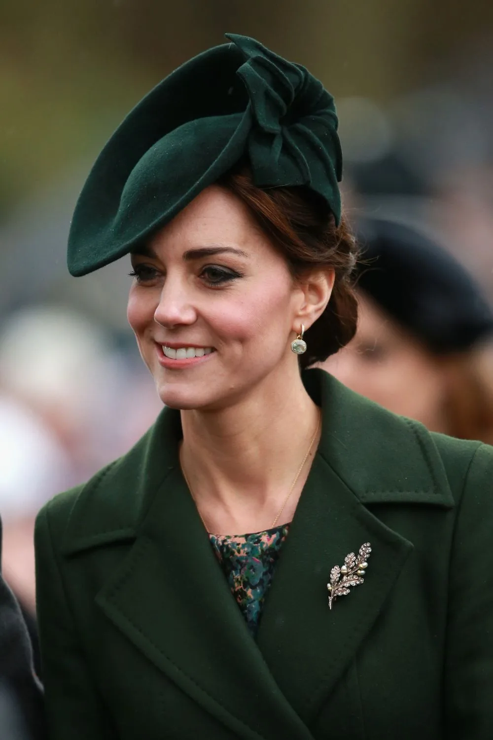 Kate in green with a fascinator