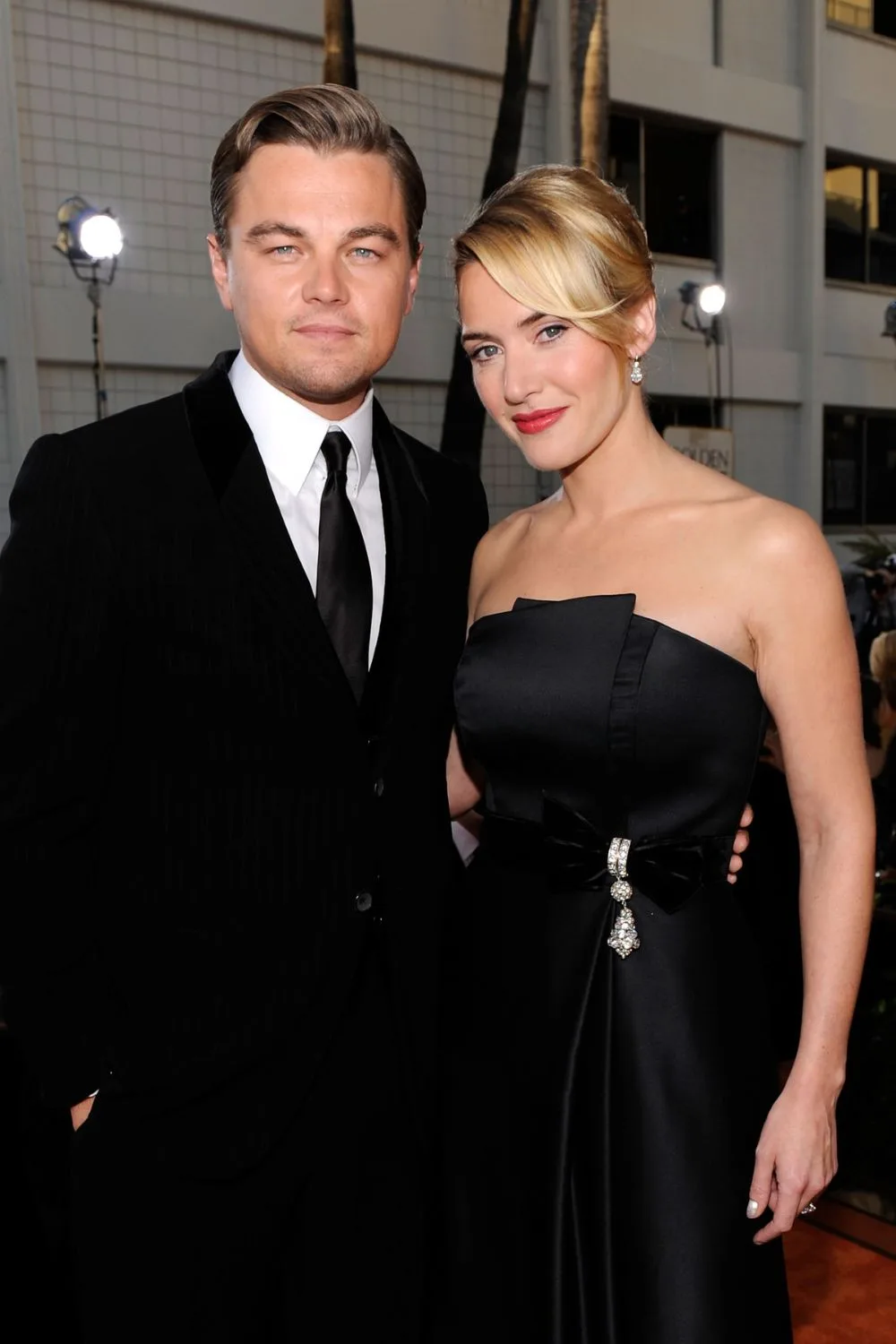 Kate in a black strapless gown with Leo in a suit 