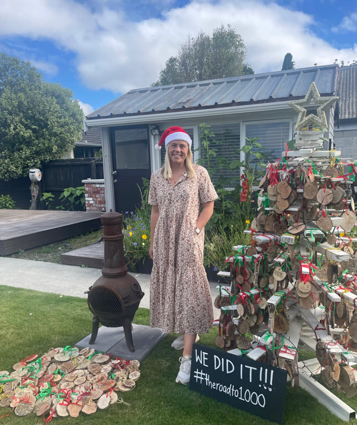 Sarah with all of the wooden Christmas decorations attached to the tree. (Image: Supplied)