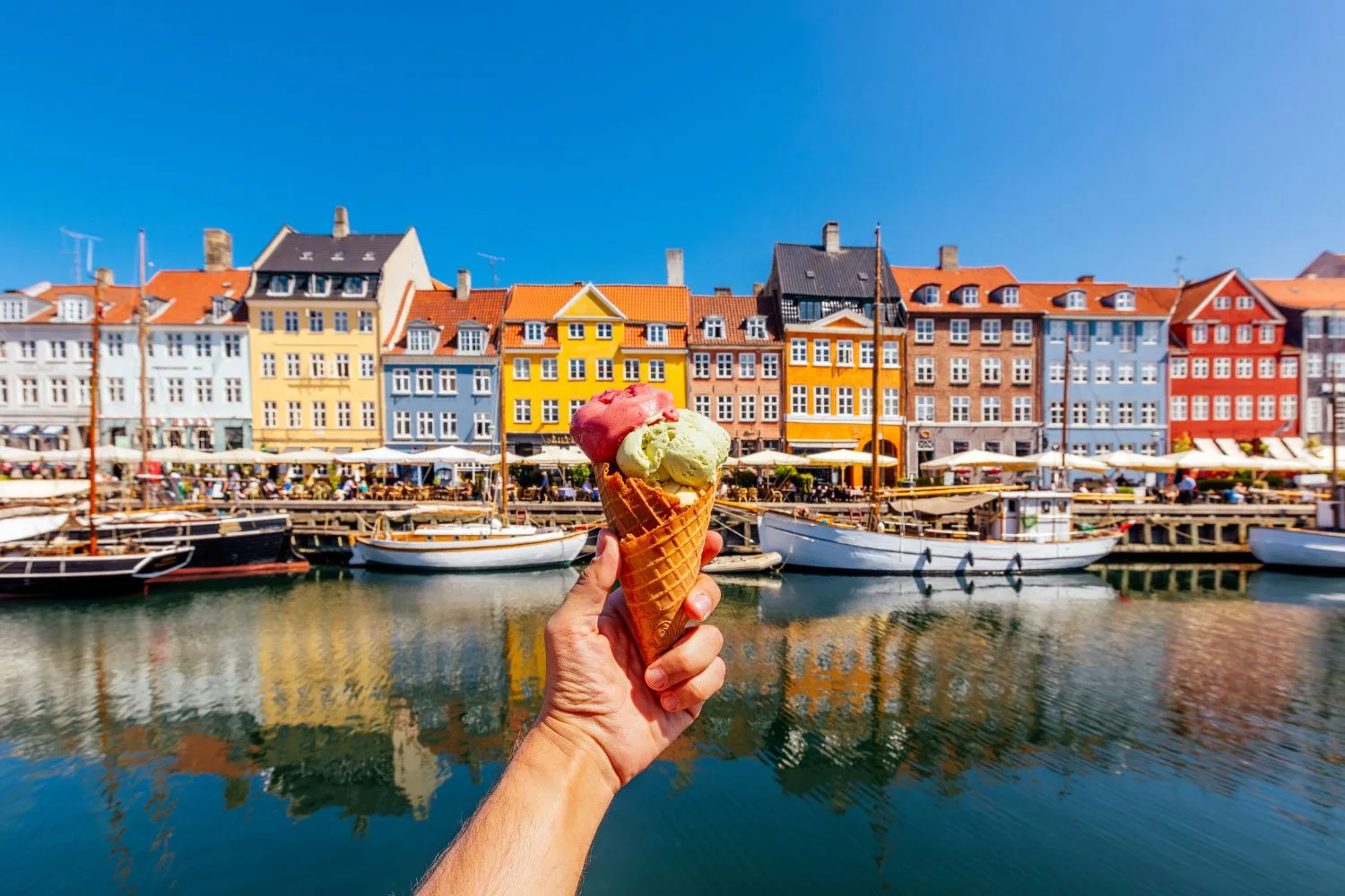 Ice cream in front of the colourful  homes in Nyhavn