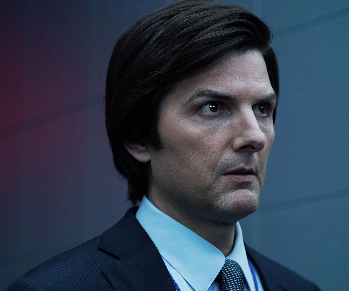 Adam Scott in Severance season two in his suit looking stressed.