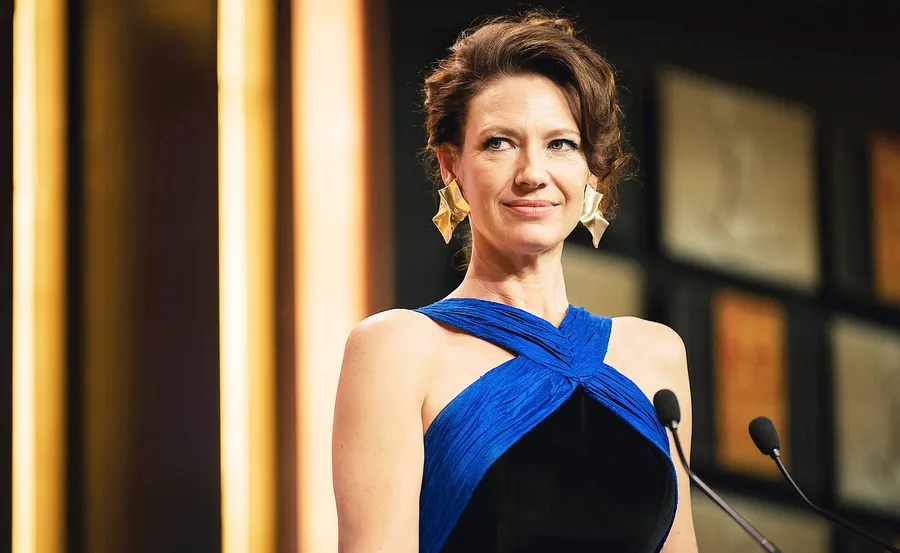 Anna Torv, playing Helen Norville in The Newsreader, is wearing a formal dress for a scene at the 1989 TV WEEK Logies.