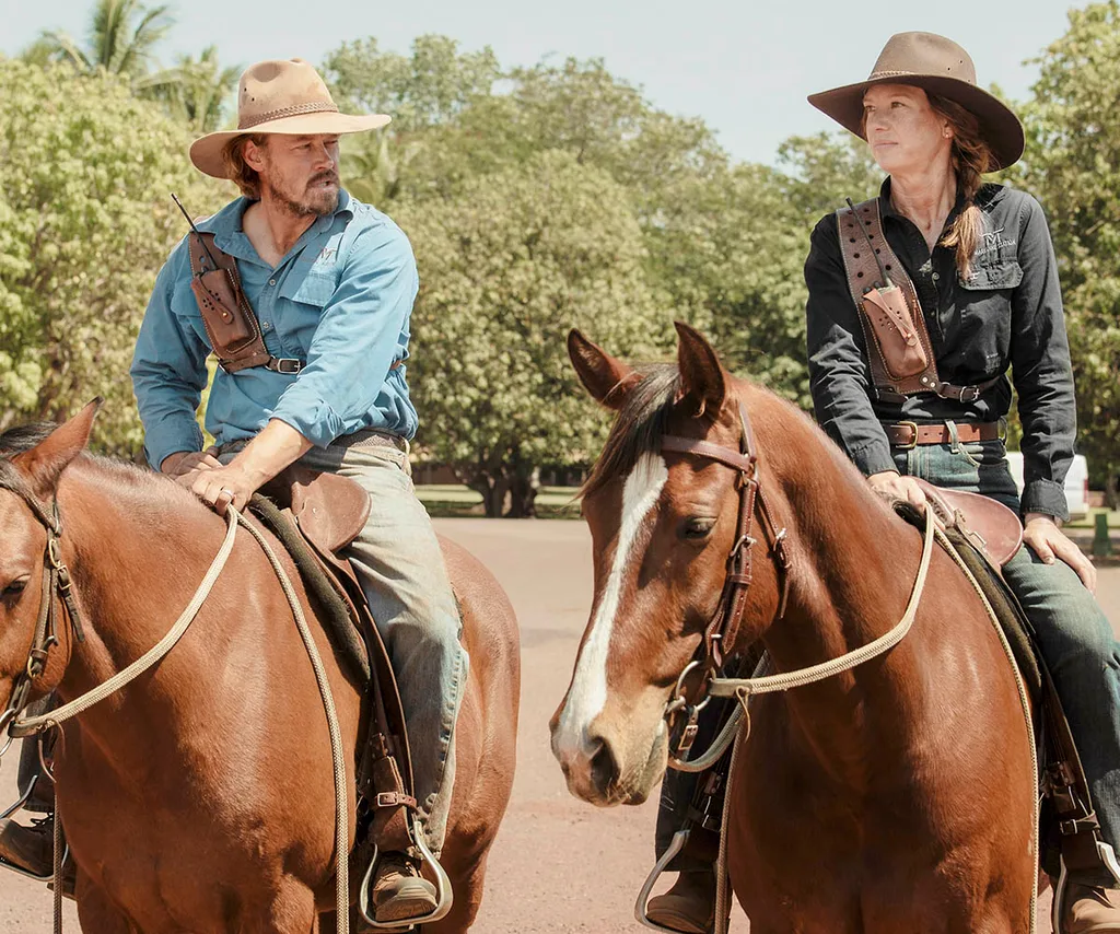 Michael Dorman and Anna Torv sit on horses alongside each other in Territory.