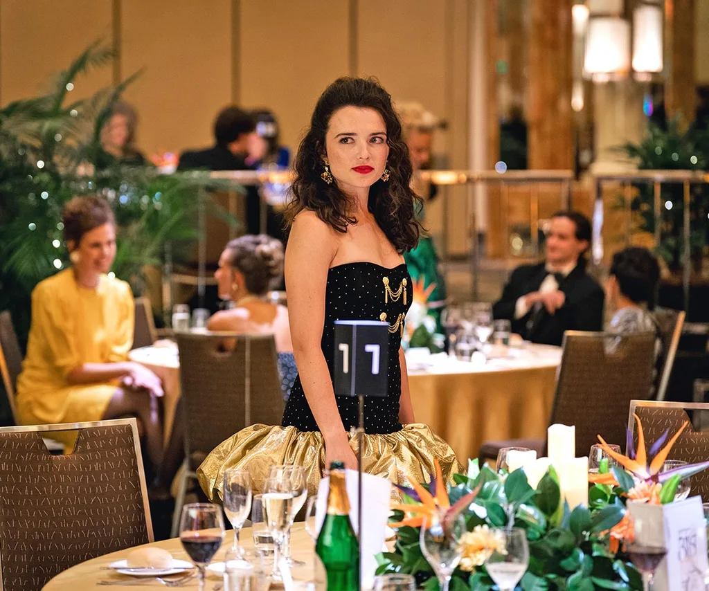 Kay, played by Philippa Northeast, stands among the tables at the Logies.