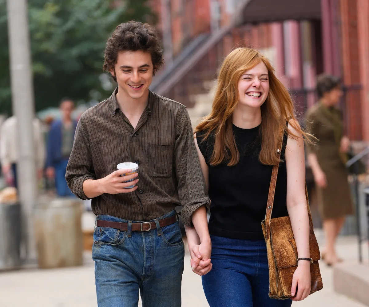 Timothee and Elle Fanning walk through the streets of New York in a still from A Complete Unknown